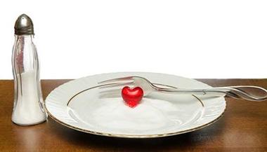 A plate of salt with a red heart figurine on it