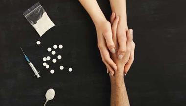 Drug user holds hands with someone to ask for help next to various substances.