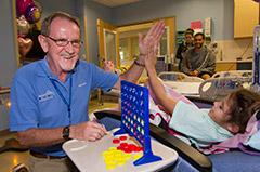 Owen Young, the volunteer of the year at Johns Hopkins All Children's Hospital, playing Connect 4 with a patient
