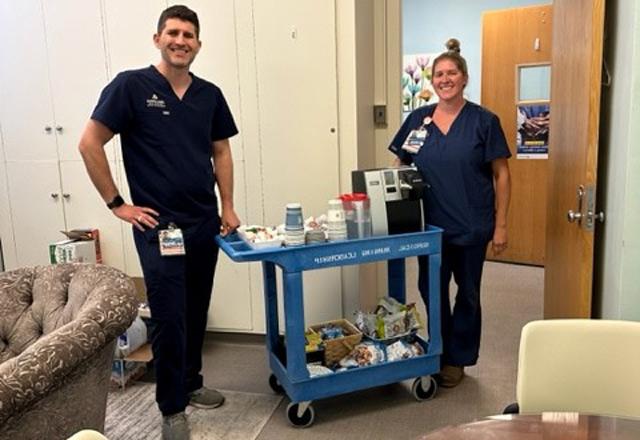 Nurses at Johns Hopkins Hospital stand with their rolling wellness cart