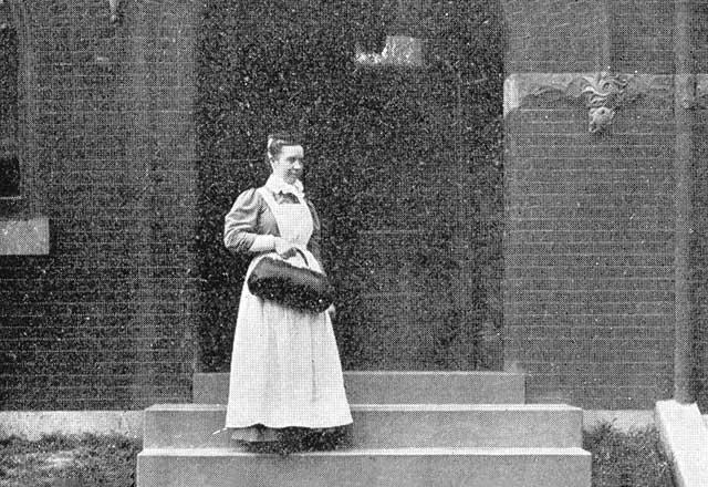 Nurse standing on stairs.